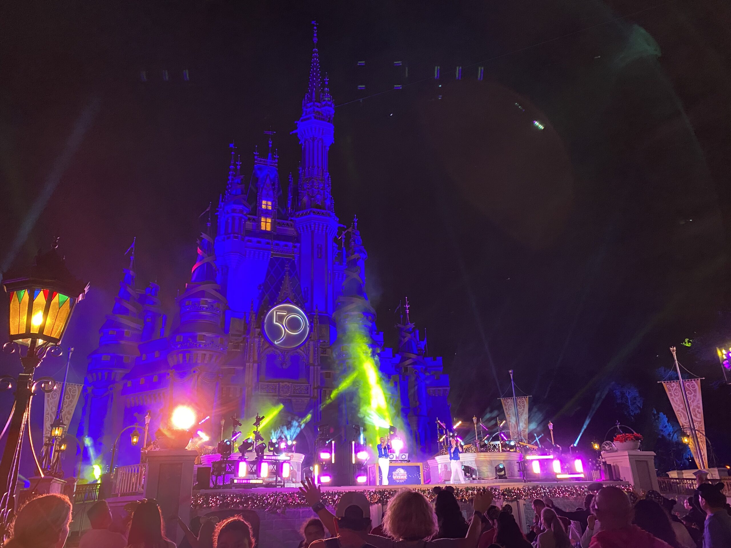 night time view of cinderella's castle with colourful strobe lights